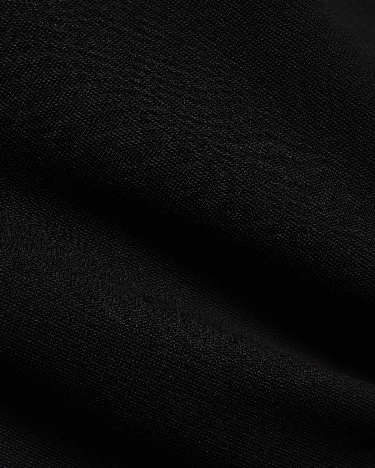 Men's Jacques Pique Track Pants in deep black, showcasing the refined, breathable pique knit fabric texture with subtle diagonal ribbing and soft folds, characteristic of premium Psycho Bunny streetwear. (6)