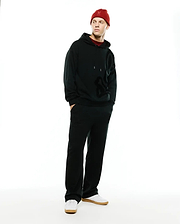 Black relaxed fit French terry hoodie with large tonal Psycho Bunny skull logo, paired with Men's Johan Straight-Leg Sweatpants and a red knit beanie featuring an embroidered bunny skull. (1)