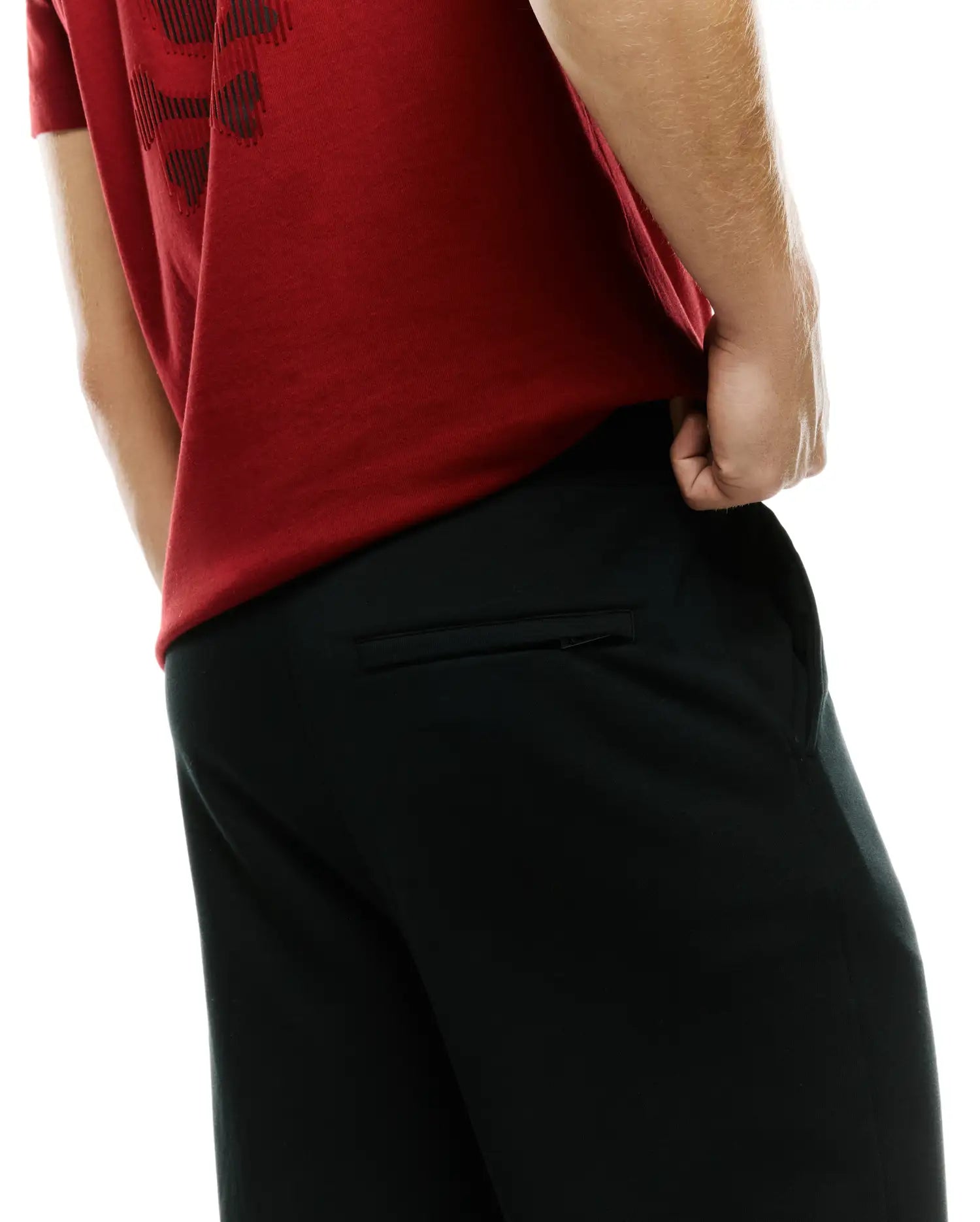 Men's Johan Straight-Leg Sweatpants in black, featuring a relaxed fit, smooth knit fabric, and a zippered back pocket, paired with a red jersey t-shirt with a dark graphic print. (3)