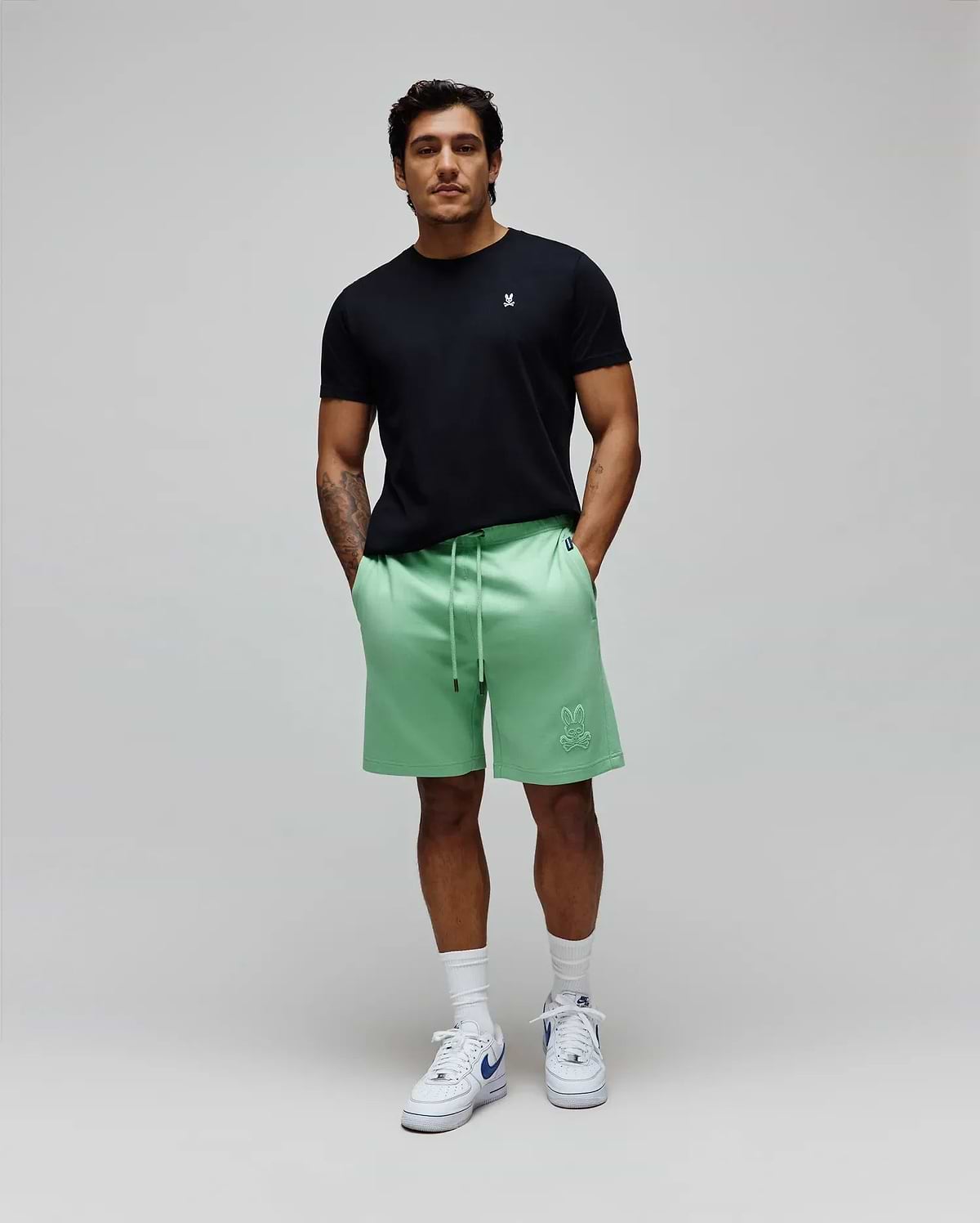 Black jersey tee with small white bunny skull embroidery on left chest, and Mens Barry Short mint green relaxed french terry shorts with large tonal bunny skull embroidery on left thigh. (5)