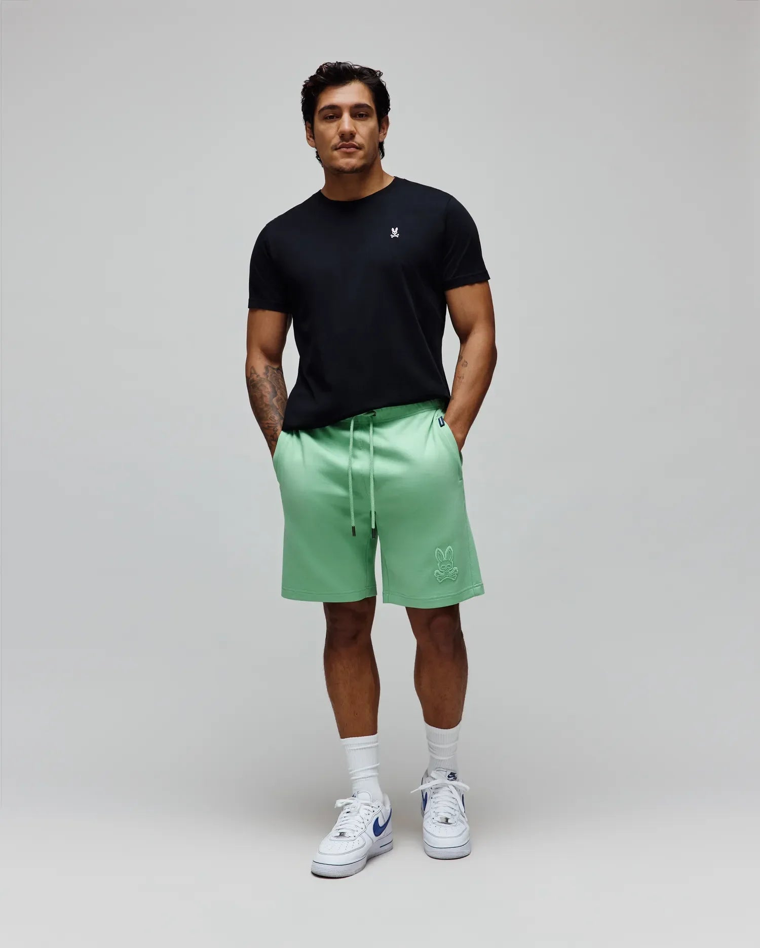 Black jersey tee with small white bunny skull embroidery on left chest, and Mens Barry Short mint green relaxed french terry shorts with large tonal bunny skull embroidery on left thigh. (5)
