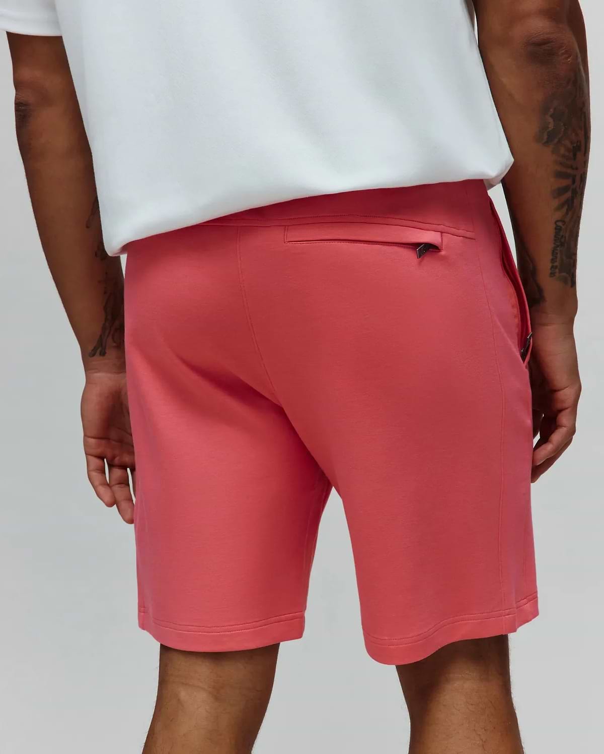 Mens Barry Short, a vibrant coral relaxed fit jersey knit short with a subtle Psycho Bunny skull logo on the sleek black zippered back pocket pull. (3)