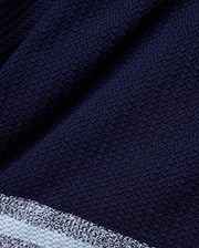 Mens Giles Knit Short 7, a navy textured knit short with a subtle striped hem featuring light blue and white accents, offering refined streetwear style.