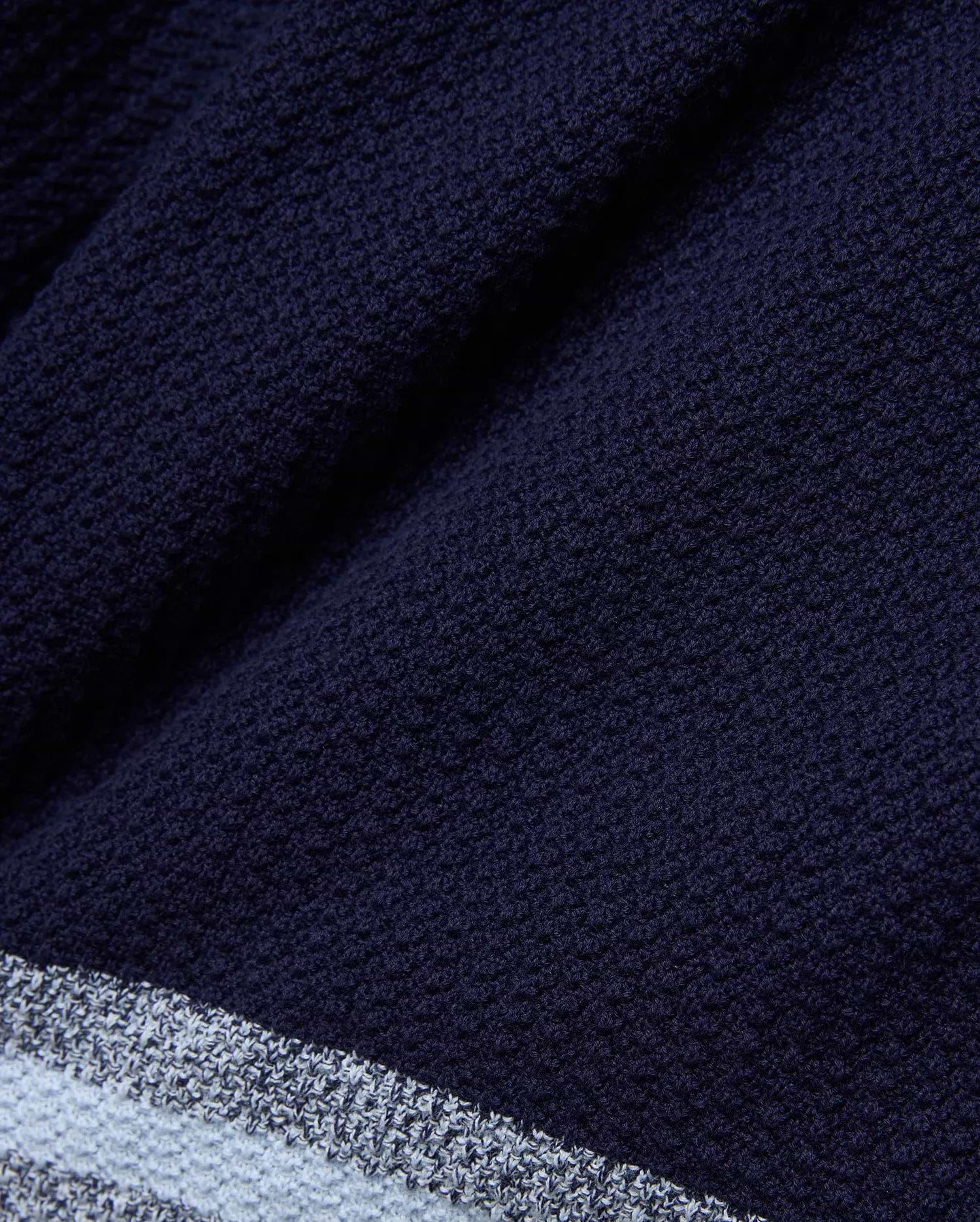 Mens Giles Knit Short 7, a navy textured knit short with a subtle striped hem featuring light blue and white accents, offering refined streetwear style.