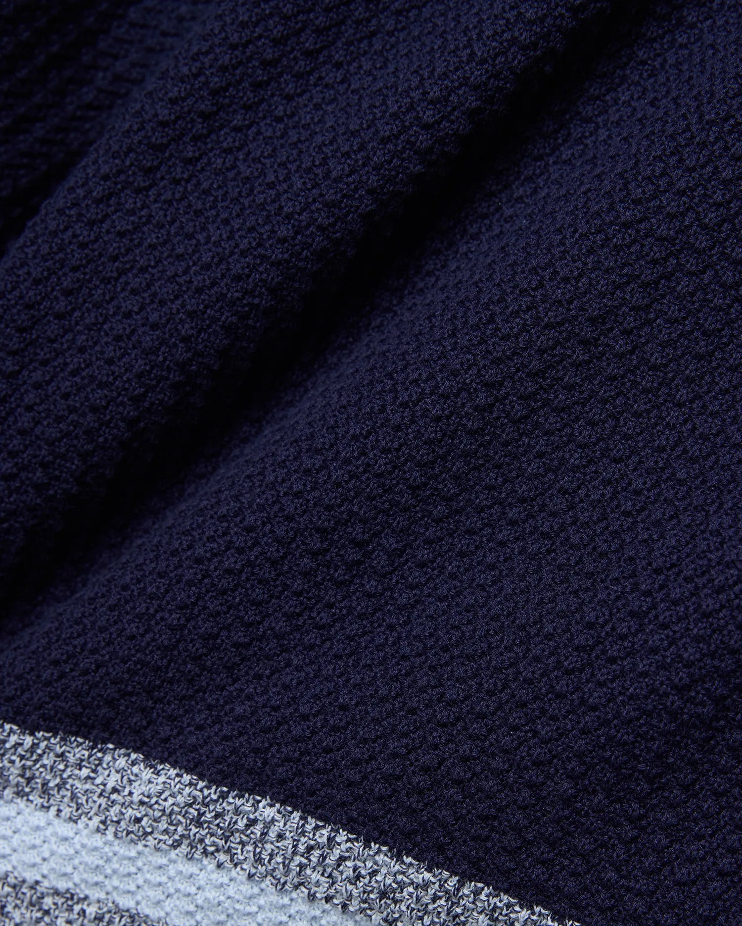 Mens Giles Knit Short 7, a navy textured knit short with a subtle striped hem featuring light blue and white accents, offering refined streetwear style.