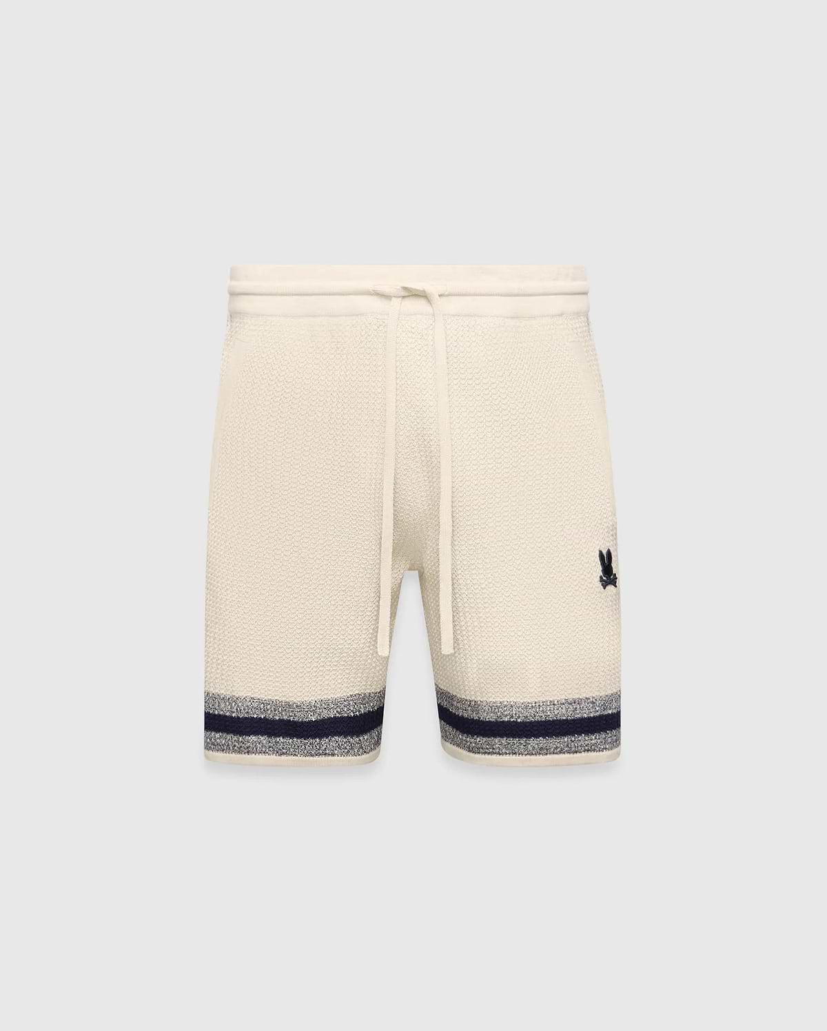 Mens Giles Knit Short 7 in cream, featuring a textured knit, drawstring waist, embroidered navy Psycho Bunny logo on the right thigh, and a navy and grey striped hem.