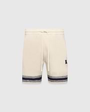 Mens Giles Knit Short 7 in cream, featuring a textured knit, drawstring waist, embroidered navy Psycho Bunny logo on the right thigh, and a navy and grey striped hem.