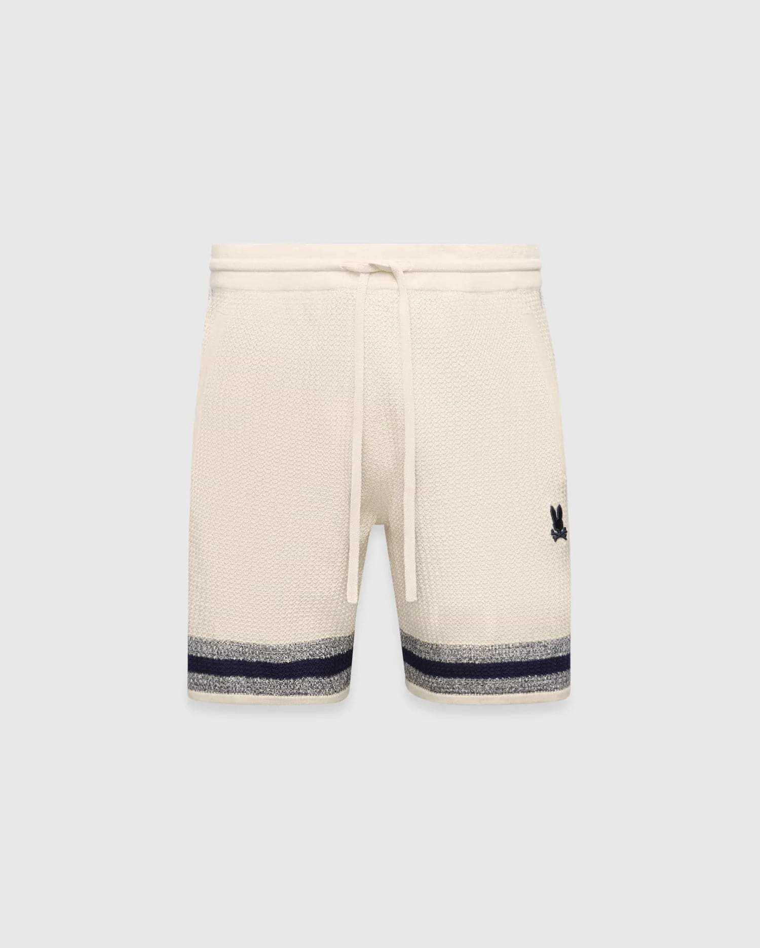 Mens Giles Knit Short 7 in cream, featuring a textured knit, drawstring waist, embroidered navy Psycho Bunny logo on the right thigh, and a navy and grey striped hem.