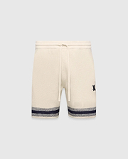 Mens Giles Knit Short 7 in cream, featuring a textured knit, drawstring waist, embroidered navy Psycho Bunny logo on the right thigh, and a navy and grey striped hem.