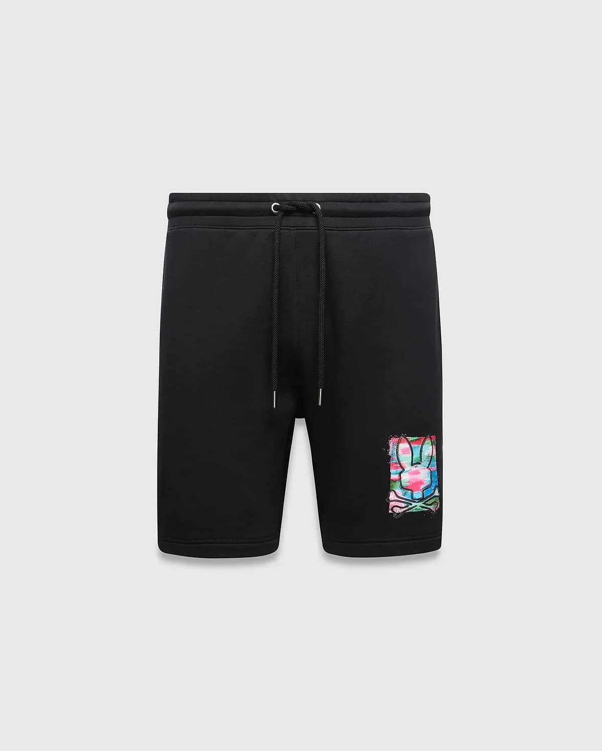 Mens Isaac Print Short, black classic fit jersey shorts featuring a drawstring waist and a large, vibrant multi-color paint splatter Psycho Bunny skull logo graphic on the lower left leg.