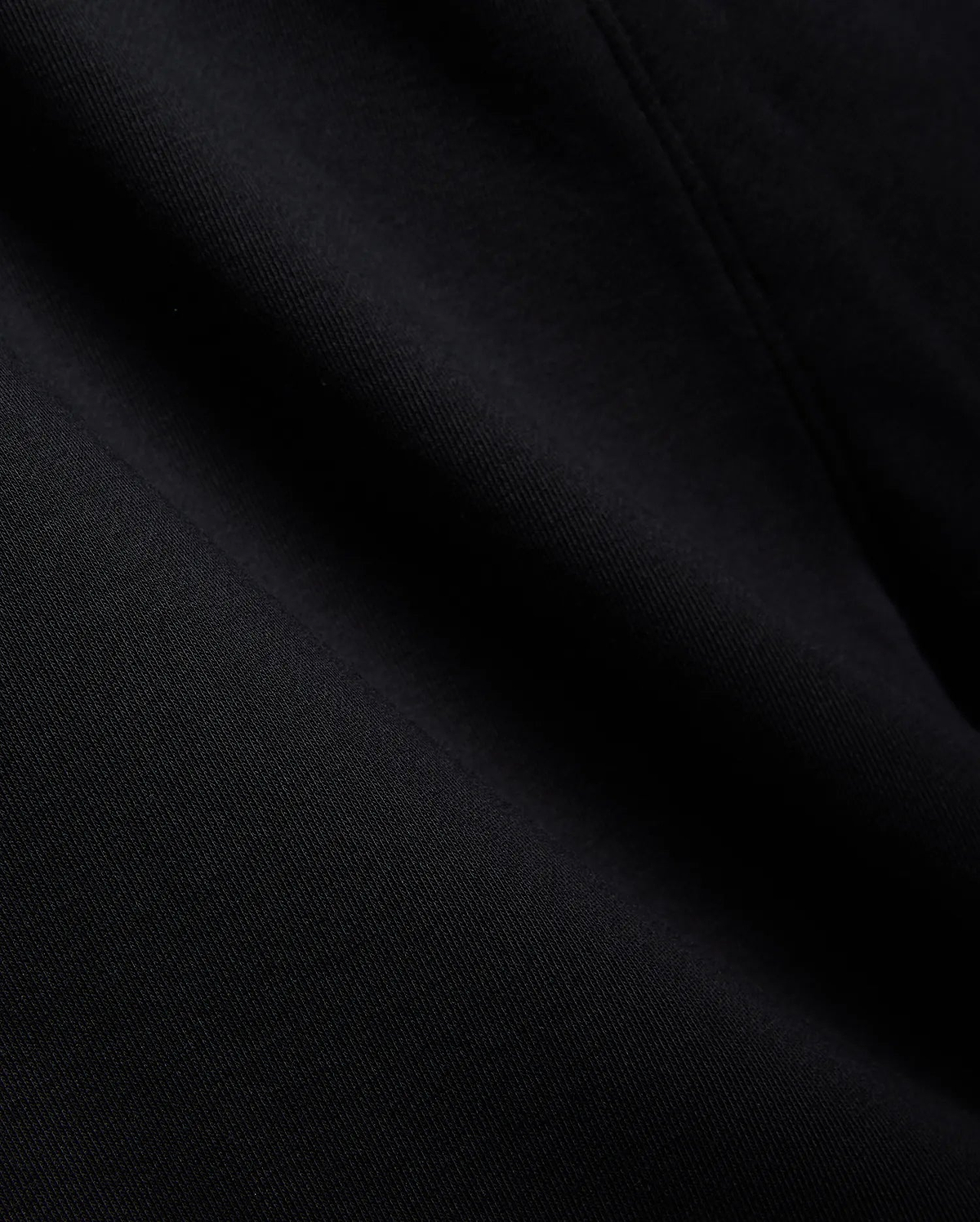 Mens Isaac Print Short in deep black, showcasing a premium, soft jersey knit fabric with a subtle, refined texture and gentle folds, embodying Psycho Bunny's quality.