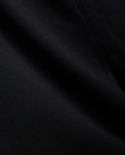Mens Isaac Print Short in deep black, showcasing a premium, soft jersey knit fabric with a subtle, refined texture and gentle folds, embodying Psycho Bunny's quality.