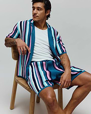 Mens Cliff Knit Short, part of a matching set, in a relaxed fit, featuring vibrant vertical stripes of teal, navy, light blue, pink, and white ribbed knit fabric.