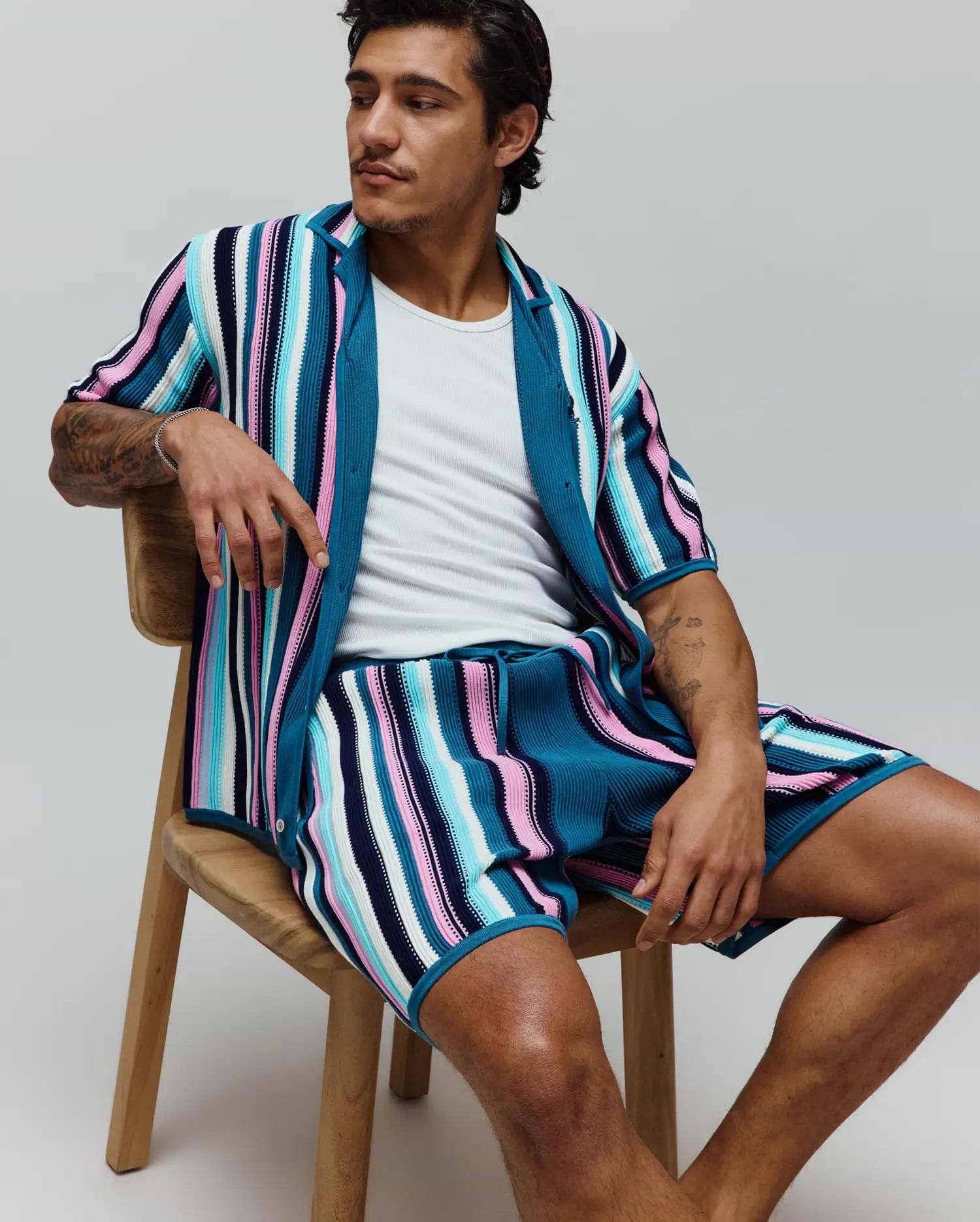 Mens Cliff Knit Short, part of a matching set, in a relaxed fit, featuring vibrant vertical stripes of teal, navy, light blue, pink, and white ribbed knit fabric.