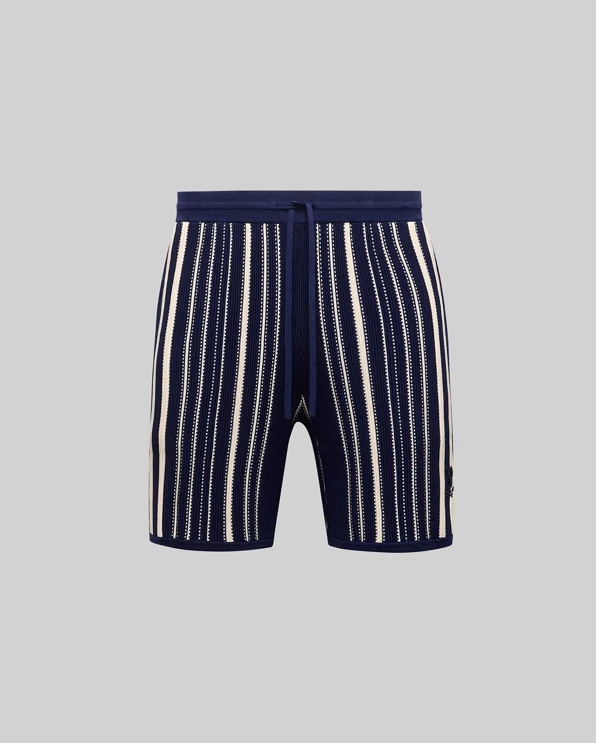 Mens Cliff Knit Short in navy ribbed knit with cream vertical stripes, some solid, some dotted, featuring a drawstring waist and small embroidered Psycho Bunny skull logo on the lower right leg.