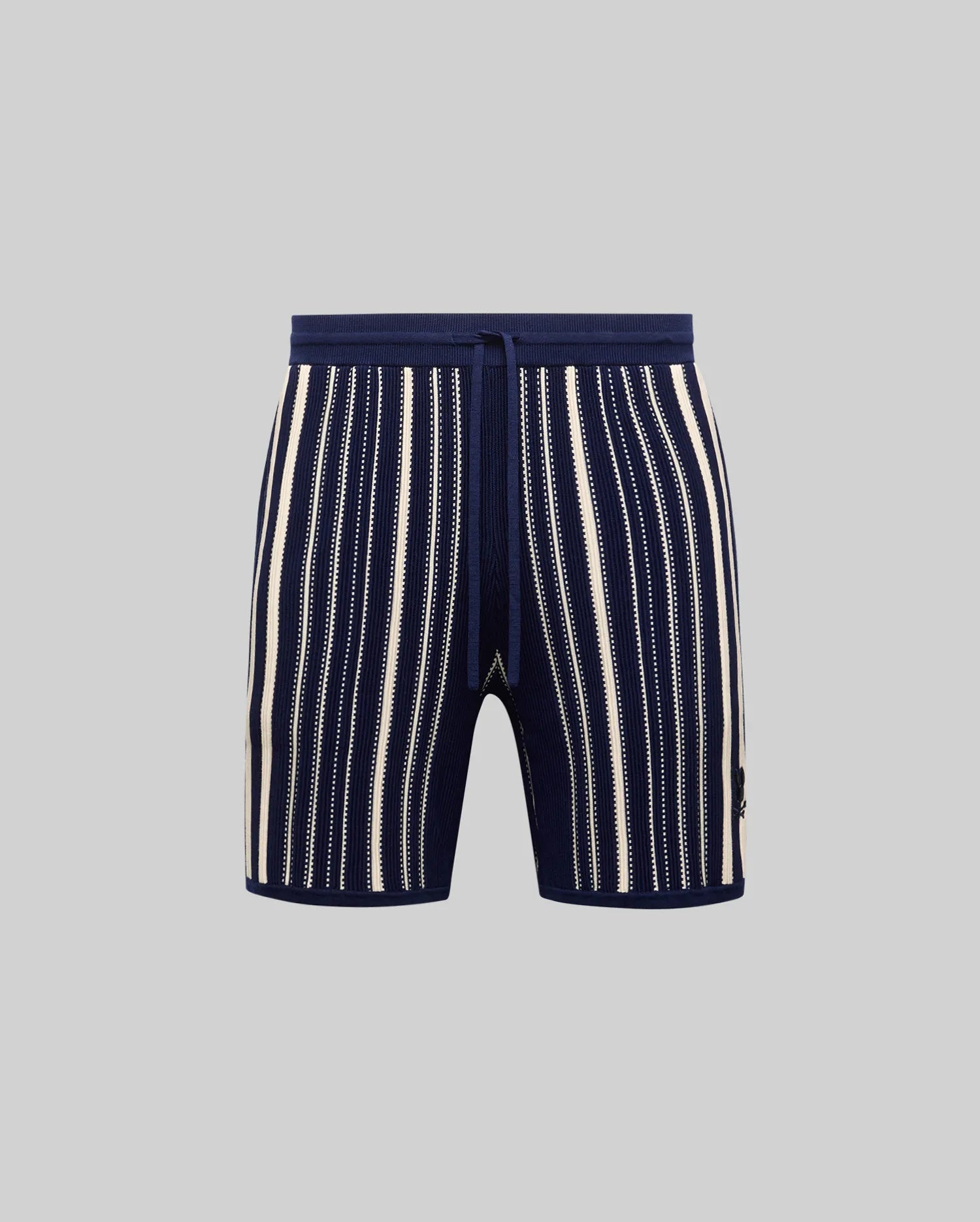 Mens Cliff Knit Short in navy ribbed knit with cream vertical stripes, some solid, some dotted, featuring a drawstring waist and small embroidered Psycho Bunny skull logo on the lower right leg.