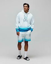 Relaxed fit white french terry hoodie and Mens Dax Sweatshort featuring a vibrant blue ombre gradient, with a large central Psycho Bunny skull logo on the hoodie and a smaller logo on the left thigh. (4)