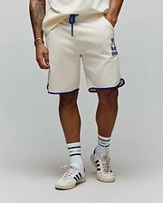 Mens Toby Short, cream french terry, relaxed fit shorts with royal blue drawstring and contrast piping. Features a medium-sized embroidered Psycho Bunny skull logo on the left thigh. (1)