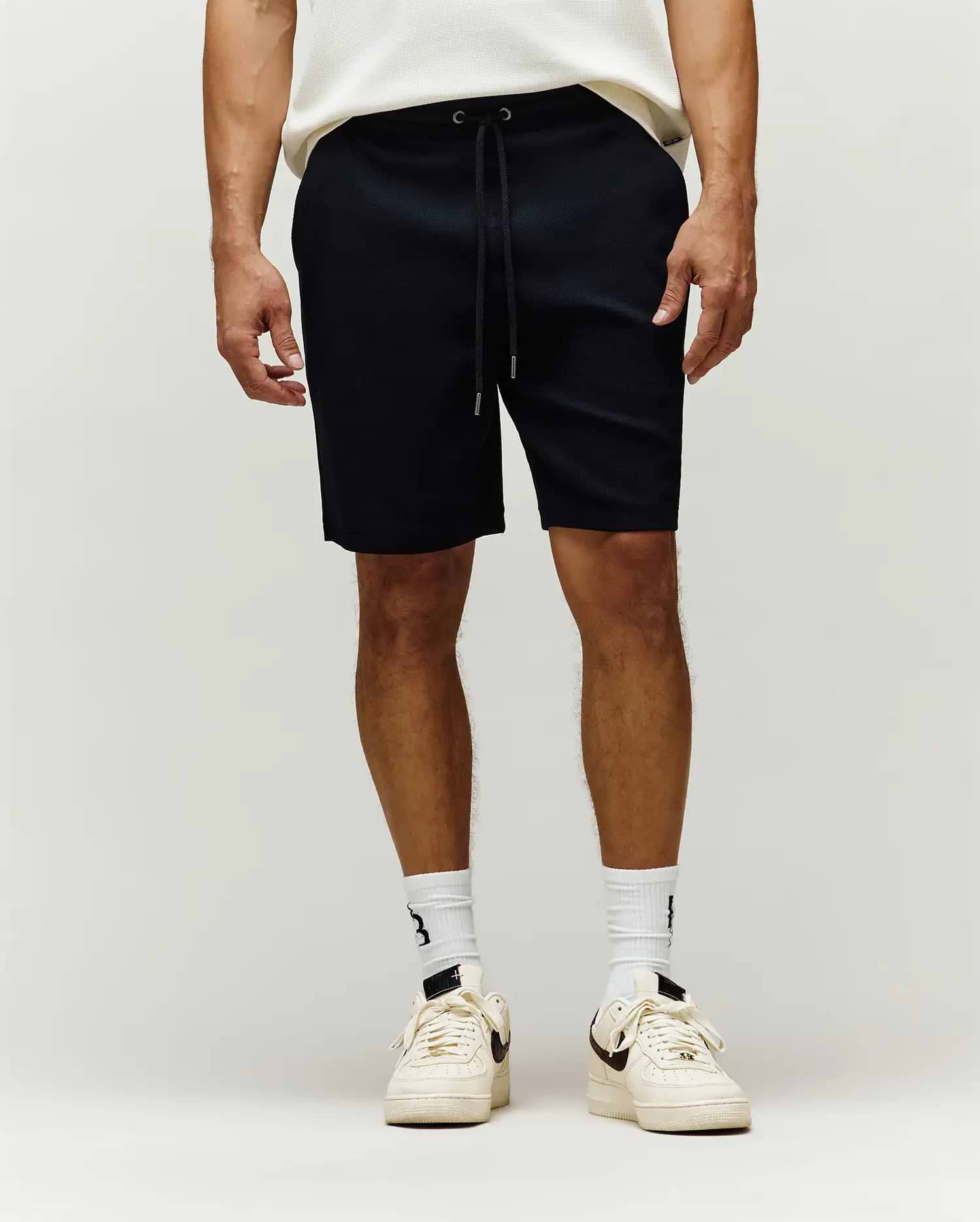 Black Mens Maxton Waffle Sweatshort with a relaxed fit, featuring a textured waffle knit fabric and an adjustable drawstring waist. (1)