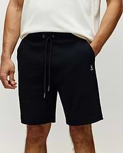 Black Mens Maxton Waffle Sweatshort with a relaxed fit, waffle knit texture, drawstring waist with silver tips, and a small white embroidered Psycho Bunny skull logo on the left thigh. (2)