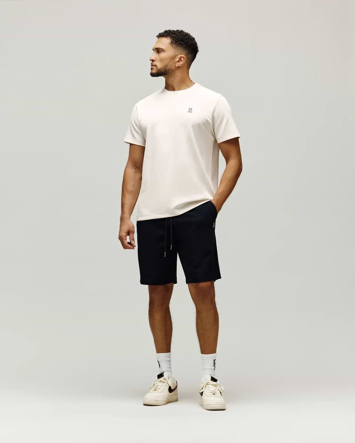 Cream jersey t-shirt with small embroidered bunny skull logo chest, and black Mens Maxton Waffle Sweatshort with drawstring, small bunny skull logo thigh. (4)