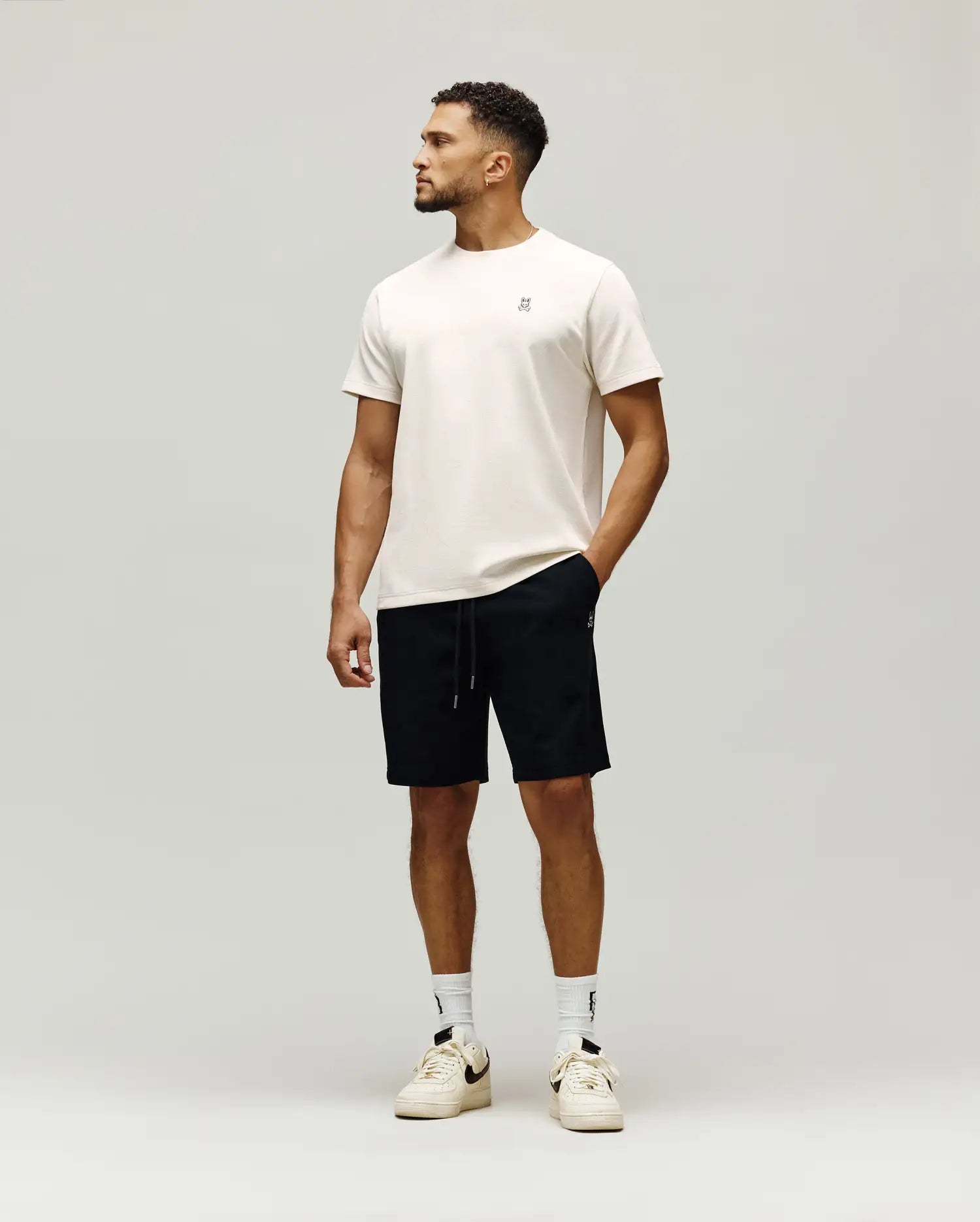 Cream jersey t-shirt with small embroidered bunny skull logo chest, and black Mens Maxton Waffle Sweatshort with drawstring, small bunny skull logo thigh. (4)
