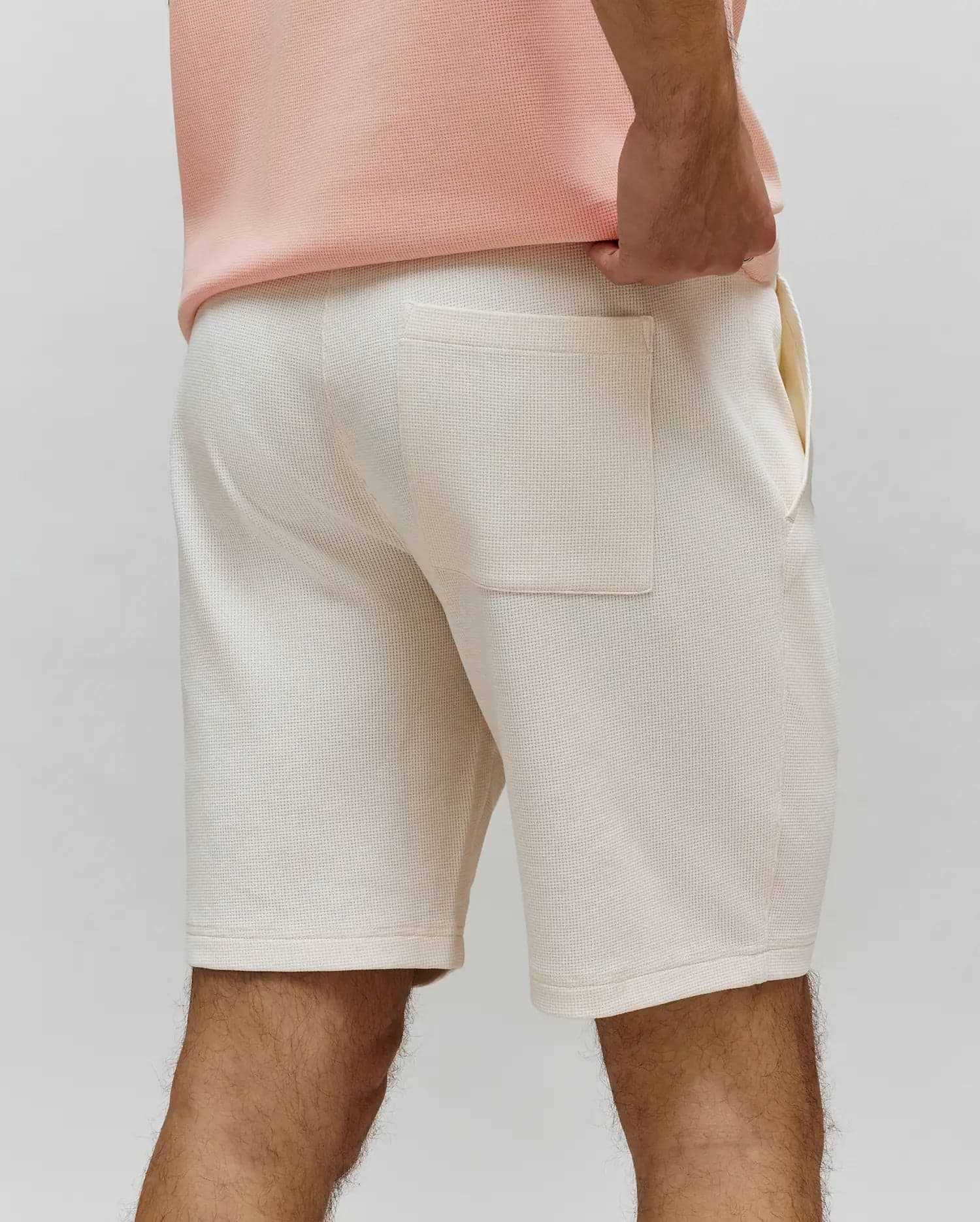 Mens Maxton Waffle Sweatshort in cream, featuring a comfortable, relaxed fit, soft waffle knit fabric, and a single back patch pocket with side pockets.