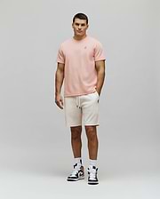 Peach textured t-shirt with a small embroidered Psycho Bunny skull logo on the left chest, paired with cream Mens Maxton Waffle Sweatshort featuring a drawstring waist and a small embroidered Psycho Bunny logo on the left thigh.