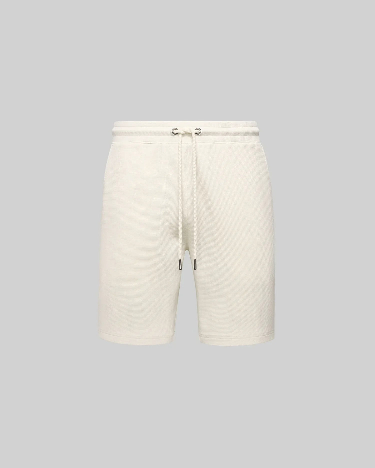 Mens Maxton Waffle Sweatshort in cream, a relaxed fit garment with a soft waffle knit texture, featuring a drawstring waist with dark metal tips. No visible Psycho Bunny logo.