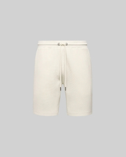 Mens Maxton Waffle Sweatshort in cream, a relaxed fit garment with a soft waffle knit texture, featuring a drawstring waist with dark metal tips. No visible Psycho Bunny logo.