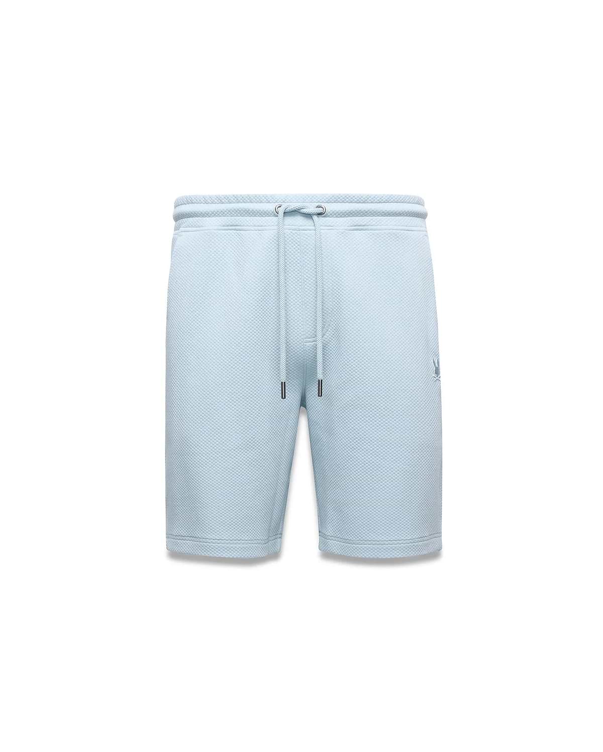 Mens Marc Textured Short, light blue with a classic fit and all-over pique texture, features a drawstring waist with dark tips and a small, embroidered Psycho Bunny skull logo on the right leg.