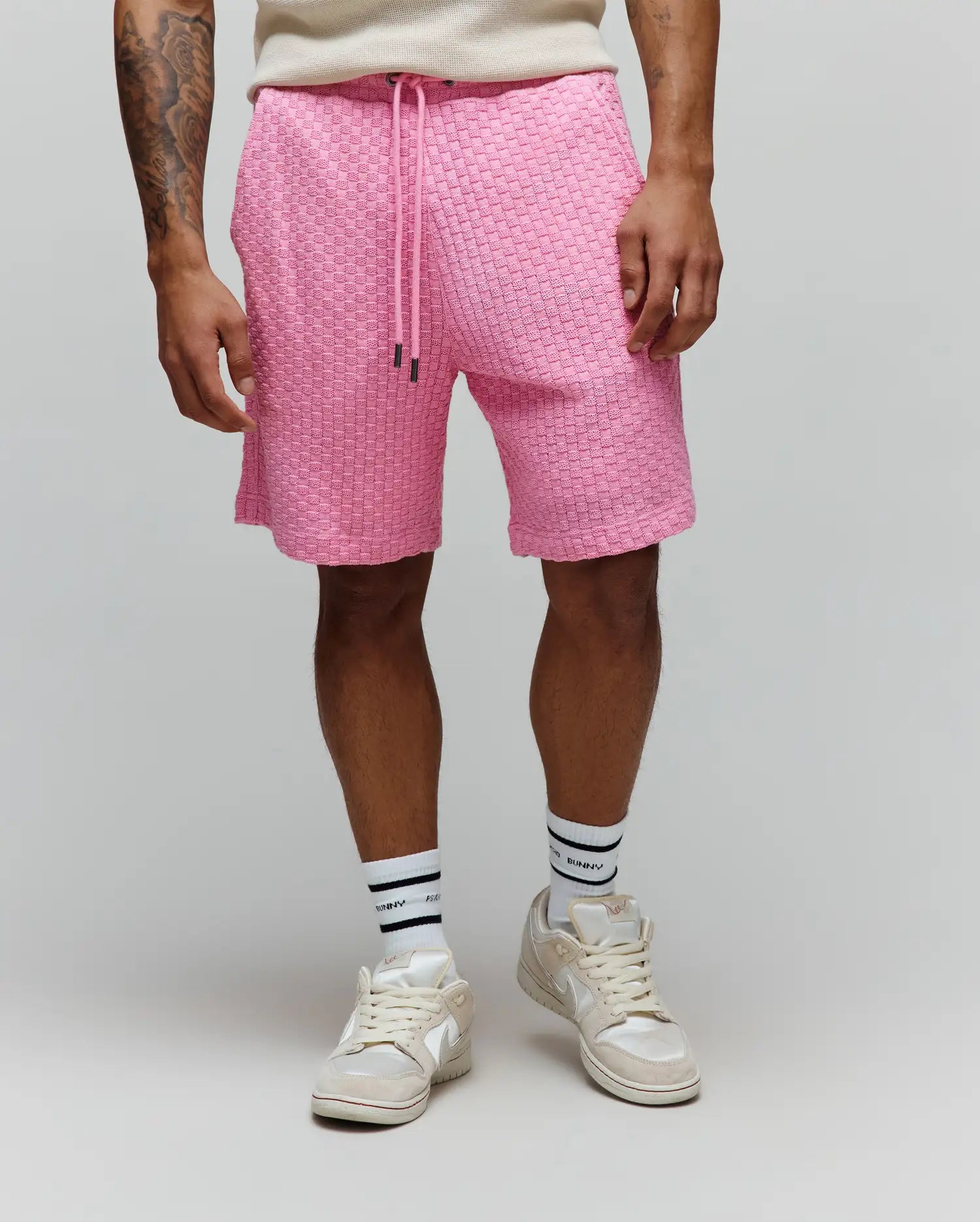 Mens Garen Knit Short in vibrant pink, featuring a relaxed fit and a distinctive woven knit texture, complete with a drawstring waist with black tips. (1)