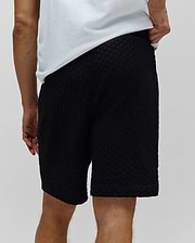 Black Mens Garen Knit Short, a relaxed fit premium streetwear piece featuring a unique, all-over textured knit fabric with a subtle geometric pattern, embodying Psycho Bunny's bold style. (3)