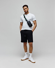 White classic fit jersey t-shirt with small embroidered Psycho Bunny logo on left chest, paired with black Mens Garen Knit Short featuring an all-over textured knit pattern and drawstring waist with silver tips. (4)