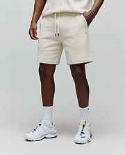 Mens Garen Knit Short, a cream relaxed-fit short with a textured waffle knit, drawstring waist with black tips, and a small embroidered Psycho Bunny logo on the left thigh. (1)