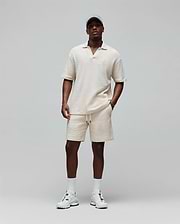 Cream textured knit polo and Mens Garen Knit Short set, both relaxed fit with small embroidered Psycho Bunny skull logos, polo on chest, shorts on left leg, shorts also have drawstring waist. (3)