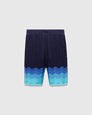 Holden Knit Short in navy with a textured wavy knit pattern, color-blocked with shades of blue and turquoise, featuring a small embroidered Psycho Bunny skull logo on the right leg.