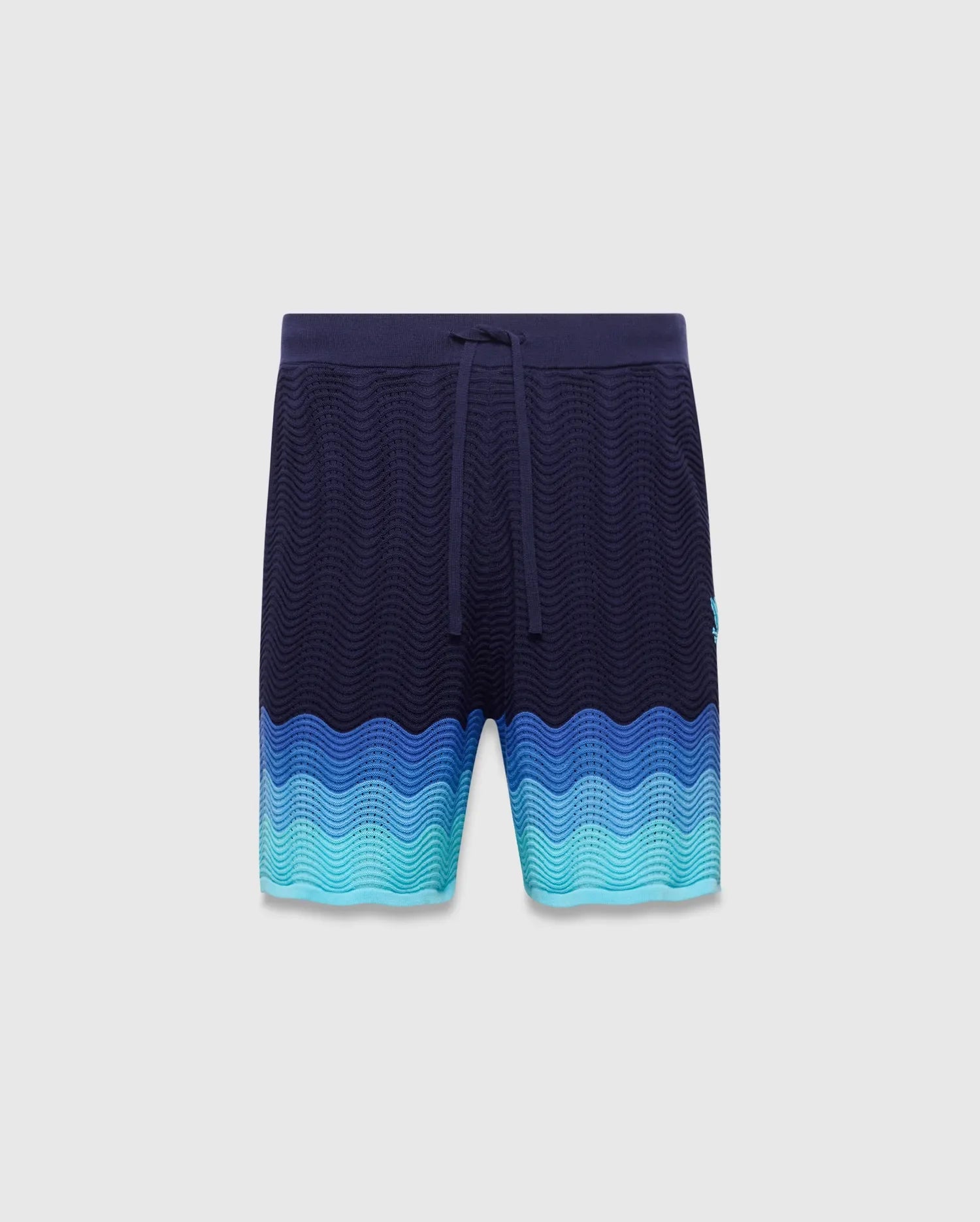 Holden Knit Short in navy with a textured wavy knit pattern, color-blocked with shades of blue and turquoise, featuring a small embroidered Psycho Bunny skull logo on the right leg.