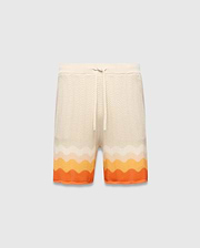 Mens Holden Knit Short 6, a cream relaxed fit knit short with a wavy texture and a bold orange and yellow gradient stripe pattern at the hem, featuring a drawstring waist.