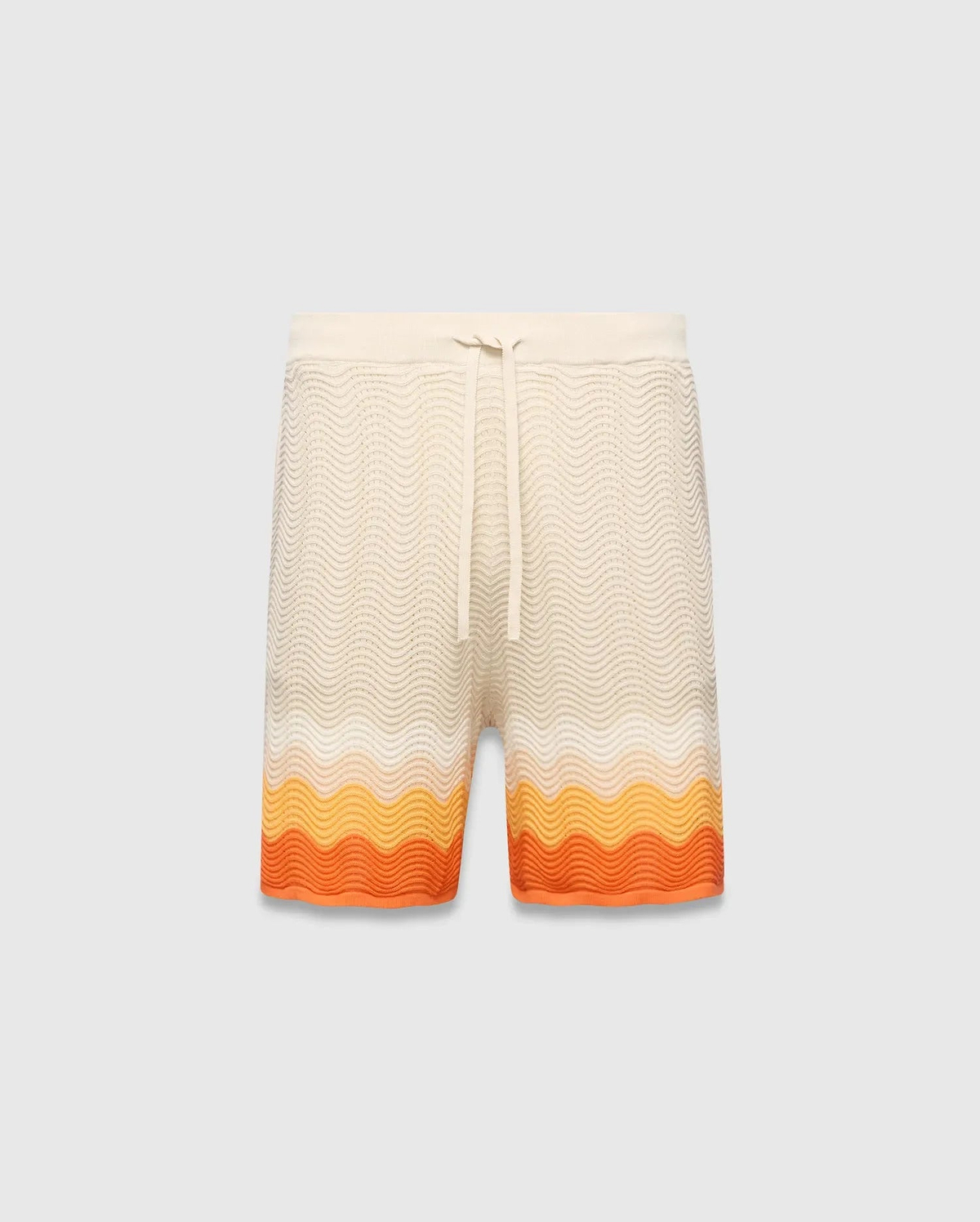 Mens Holden Knit Short 6, a cream relaxed fit knit short with a wavy texture and a bold orange and yellow gradient stripe pattern at the hem, featuring a drawstring waist.