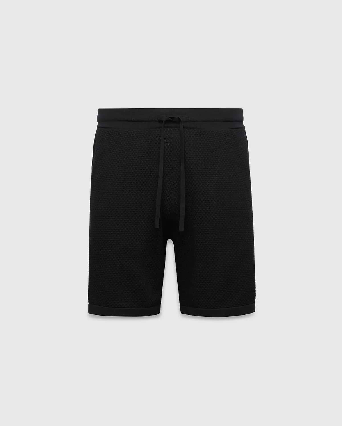 Black MENS DEVON KNIT SHORT with a relaxed fit, featuring a textured knit fabric, ribbed waistband, and drawstring closure. No visible Psycho Bunny logo.