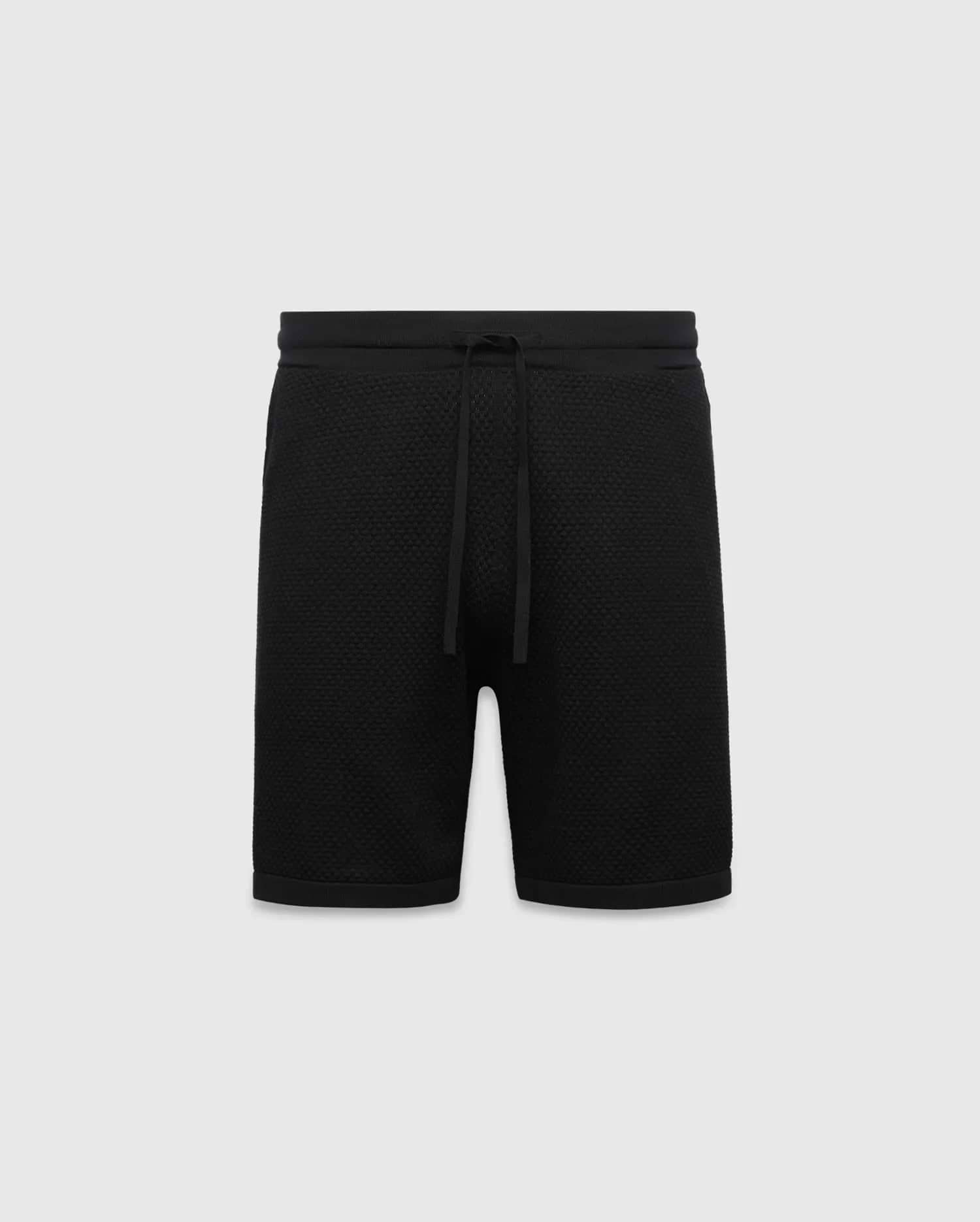 Black MENS DEVON KNIT SHORT with a relaxed fit, featuring a textured knit fabric, ribbed waistband, and drawstring closure. No visible Psycho Bunny logo.