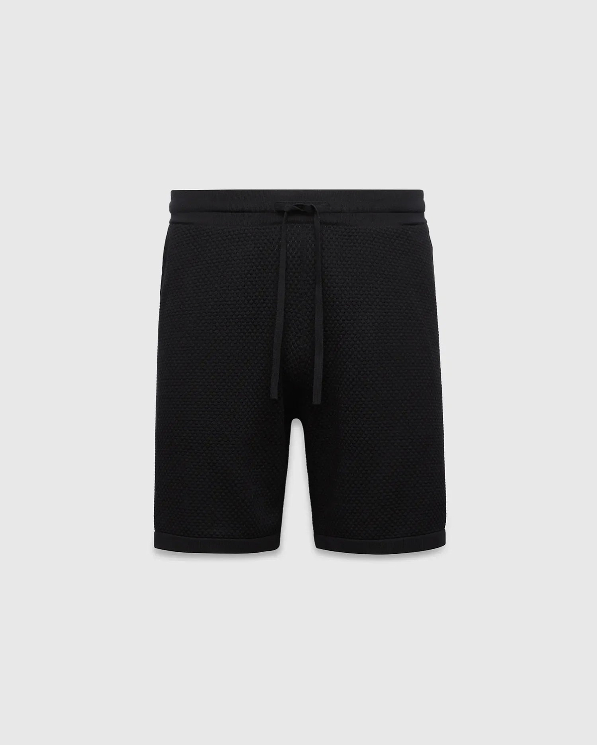 Black MENS DEVON KNIT SHORT with a relaxed fit, featuring a textured knit fabric, ribbed waistband, and drawstring closure. No visible Psycho Bunny logo.