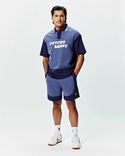 Relaxed fit two-tone blue jersey polo with large white PSYCHO BUNNY chest graphic, striped collar, and matching color-blocked Mens Kelly Short featuring a small embroidered skull logo. (4)