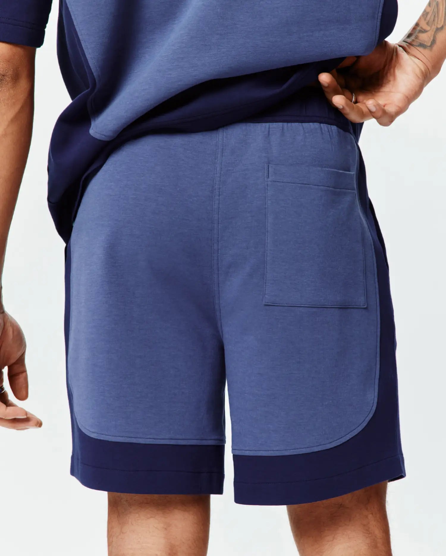Mens Kelly Short: Relaxed fit heather blue jersey shorts featuring dark navy color-block side panels, an elastic waistband, and a single back patch pocket. (3)