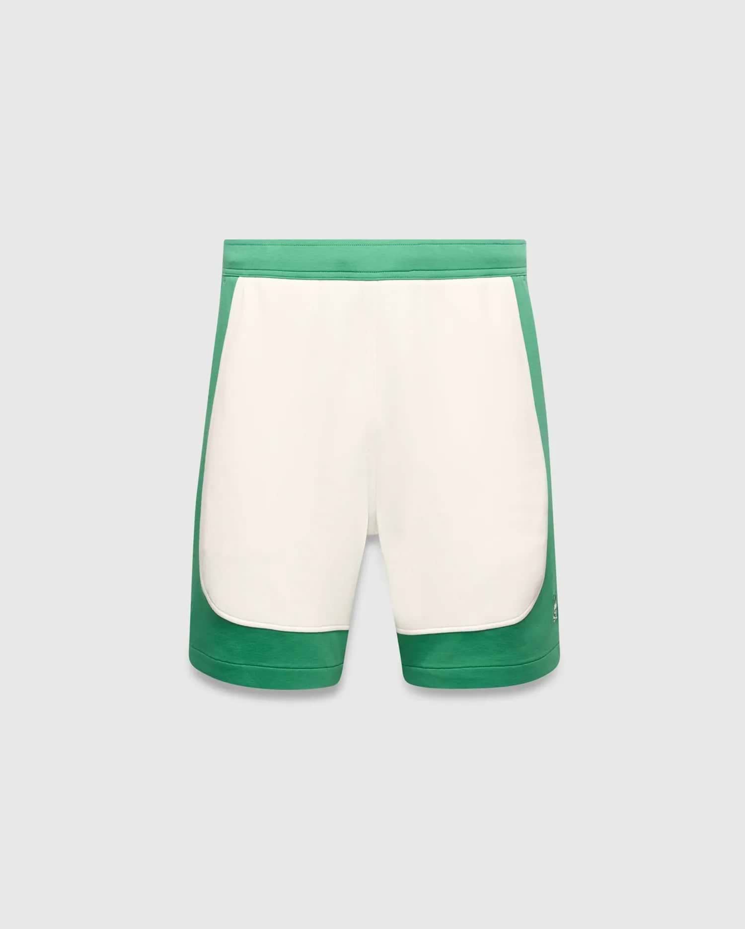 Mens Kelly Short, a color-blocked design with vibrant green outer panels and a cream central panel, featuring a small embroidered Psycho Bunny skull logo on the lower left leg. Smooth knit fabric, classic fit. (5)