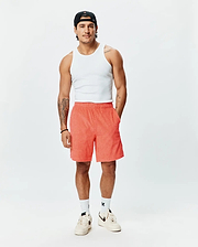 Mens Tristan Short, a premium Psycho Bunny relaxed fit short in vibrant coral, featuring an all-over embossed geometric diamond pattern and practical side pockets.