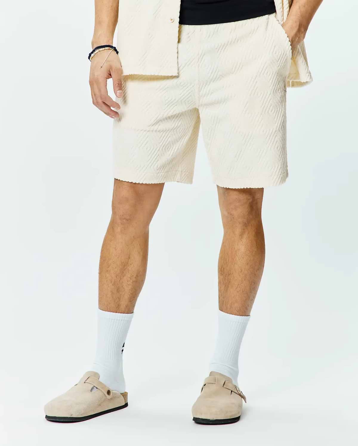 Mens Tristan Short, a premium relaxed fit cream jacquard knit short, showcasing an all-over subtle diamond pattern, comfortable elastic waistband, and practical side pockets for refined streetwear style.