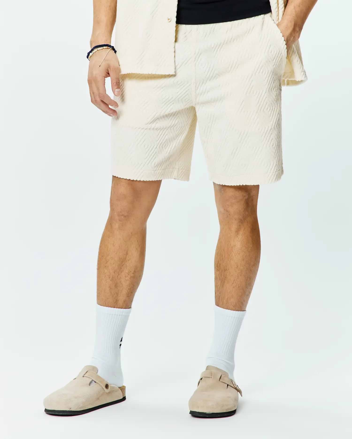 Mens Tristan Short, a premium relaxed fit cream jacquard knit short, showcasing an all-over subtle diamond pattern, comfortable elastic waistband, and practical side pockets for refined streetwear style.