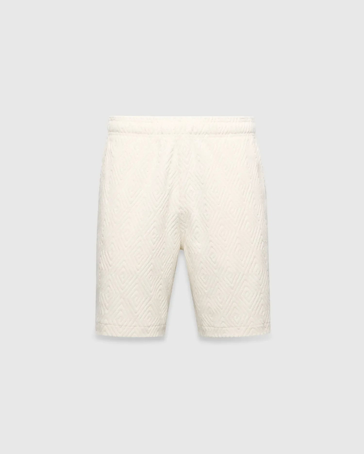 Mens Tristan Short in cream, a relaxed fit short with an all-over raised geometric concentric square pattern on textured fabric, no visible Psycho Bunny logo.